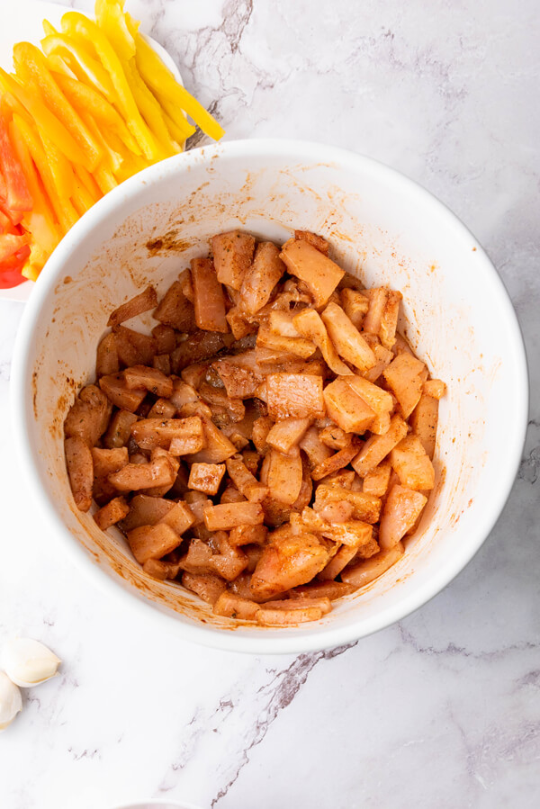 Combining the diced chicken, olive oil, and all the spices