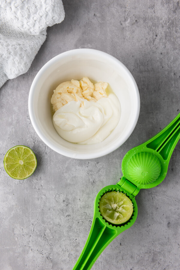 Mixing Mexican crema, mayonnaise, and lime juice