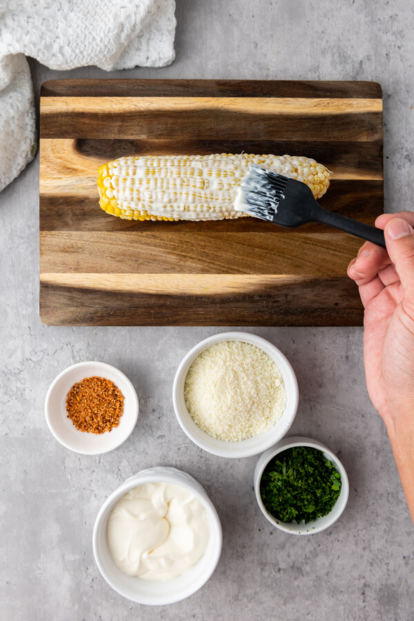 Covering the corn with our mixed cream