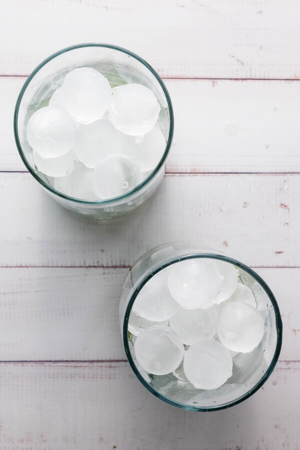 Filling two cups with ice