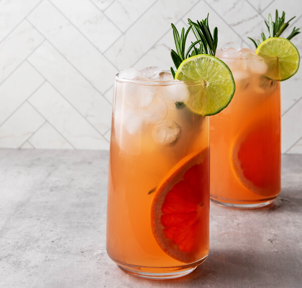 Adding a slice of lime and a sprig of rosemary