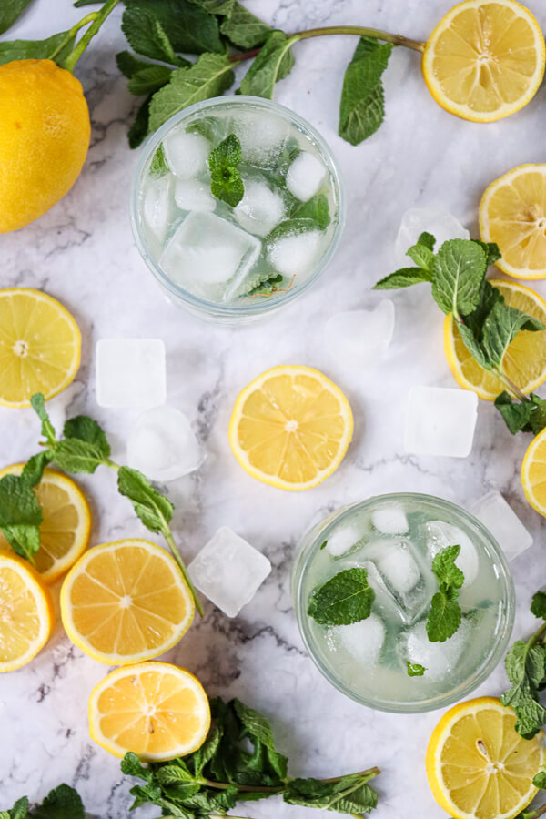 Mint-lemon mixture, ice, and sparkling water in glasses