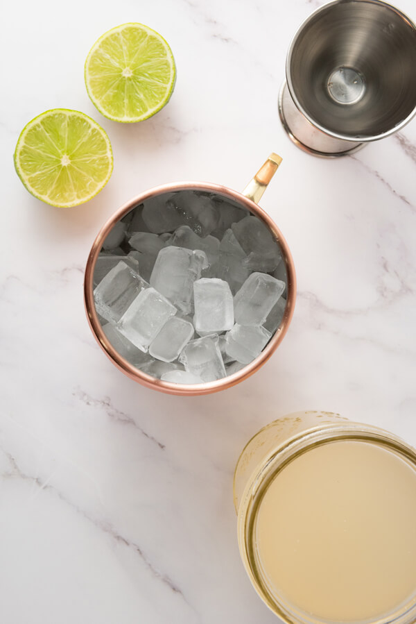 Filling a copper mug with ice cubes
