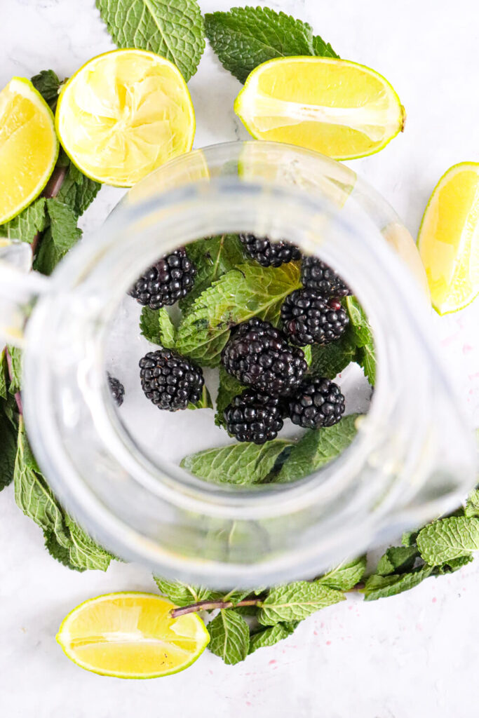 Muddling the blackberries and mint leaves together