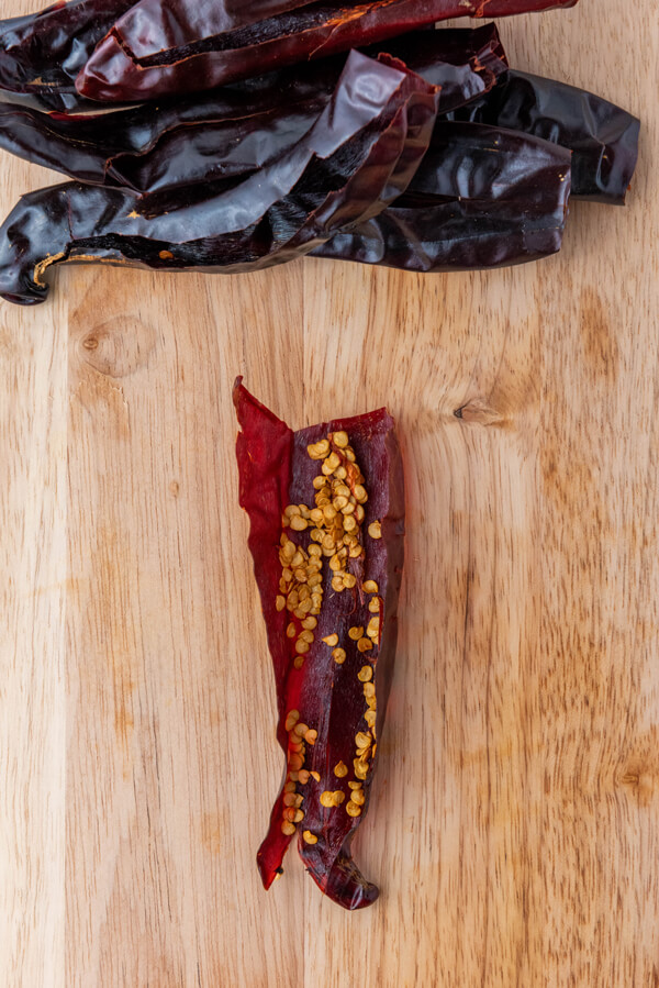 Removing the seeds from the guajillo chilies