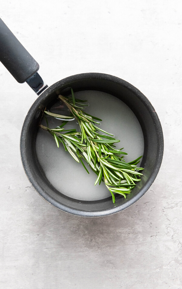 Pot with water, sugar and rosemary