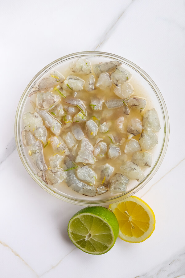 Mixing the shrimp with lime and lemon juice