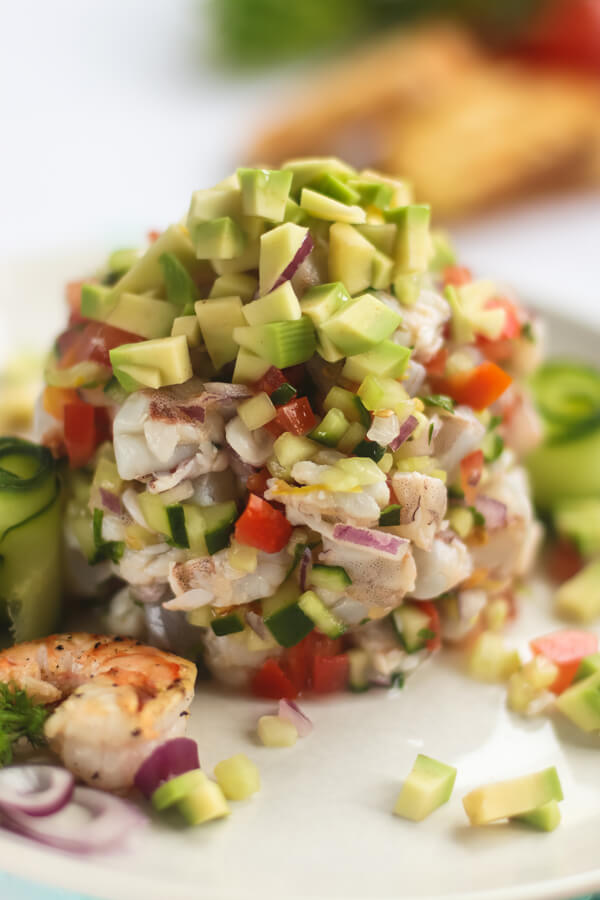 Serving shrimp ceviche with avocado cubes