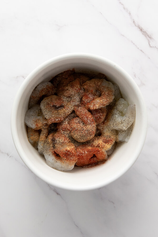 Mixing shrimps with olive oil and seasonings