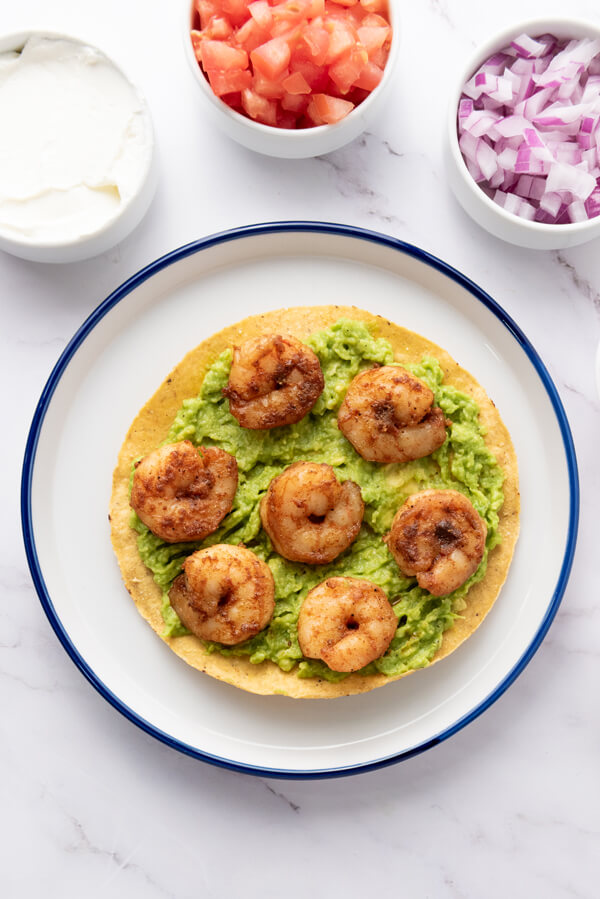 Adding some shrimps on top of the avocado