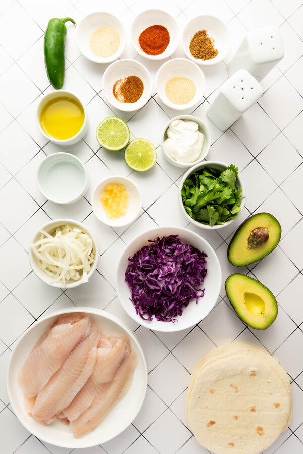 Kitchen counter top with all of the ingredients to make fish tacos