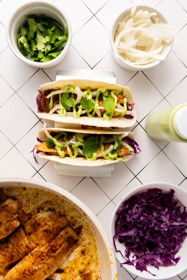 Adding the Tilapia, avocado cilantro sauce, onions, and cilantro