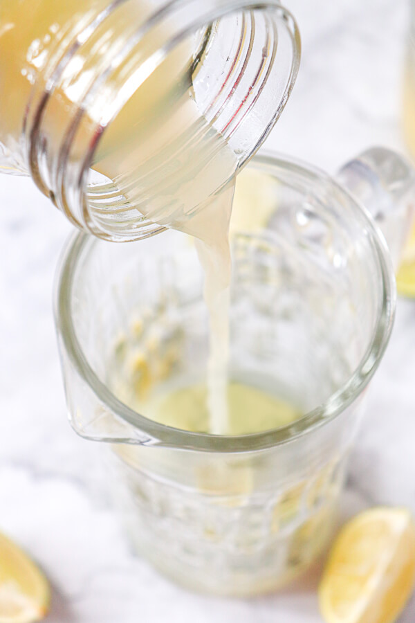 Putting lime juice into a jug