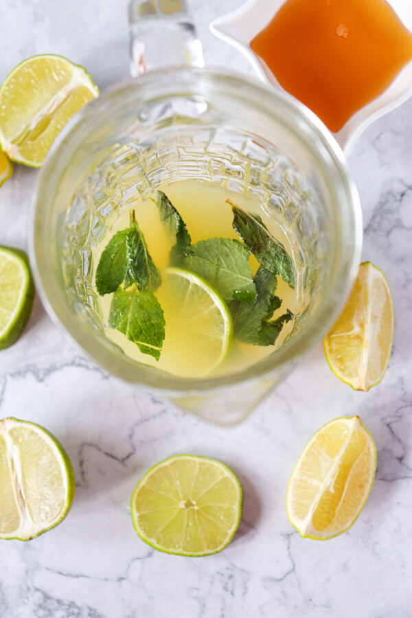 Adding mint leaves to the lime juice