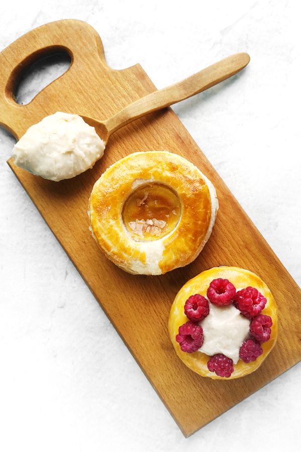 Filling each puff pastry shell with the cooled cream and raspberries