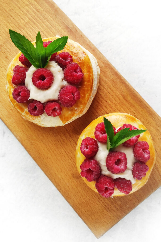 Serving the Cream Puffs with raspberries and mint leaves