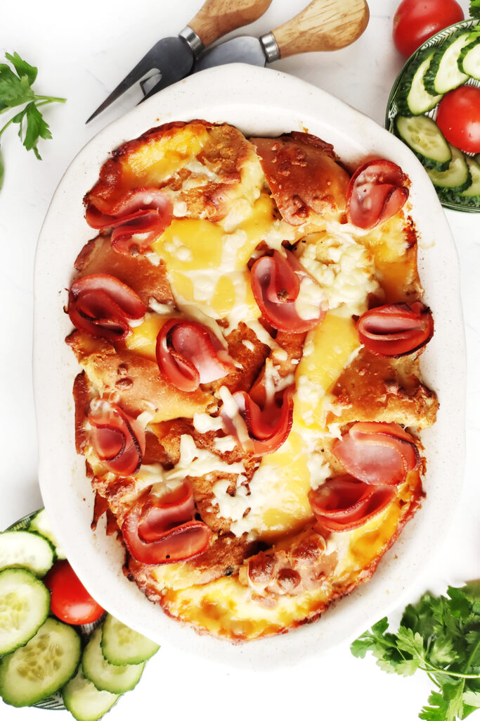 Baked Ham and Cheese Pull-Apart Sliders served with a salad
