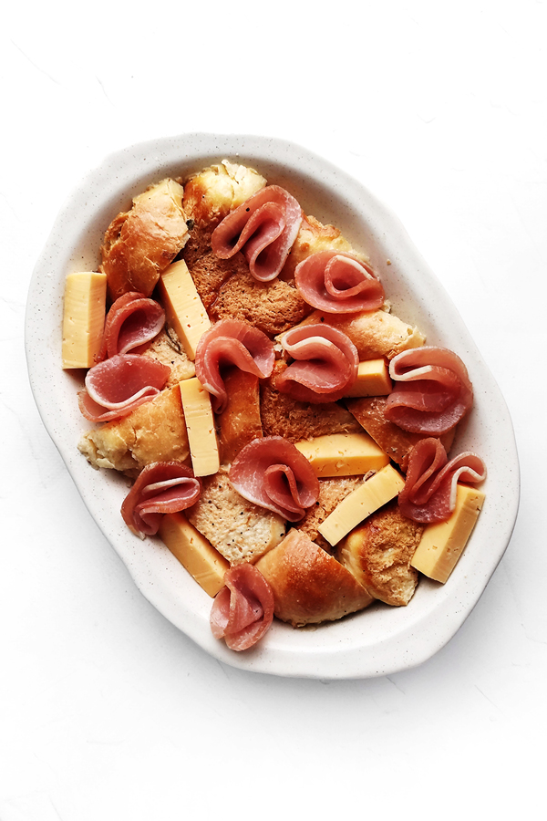 Adding folded ham slices and cheese bars 
