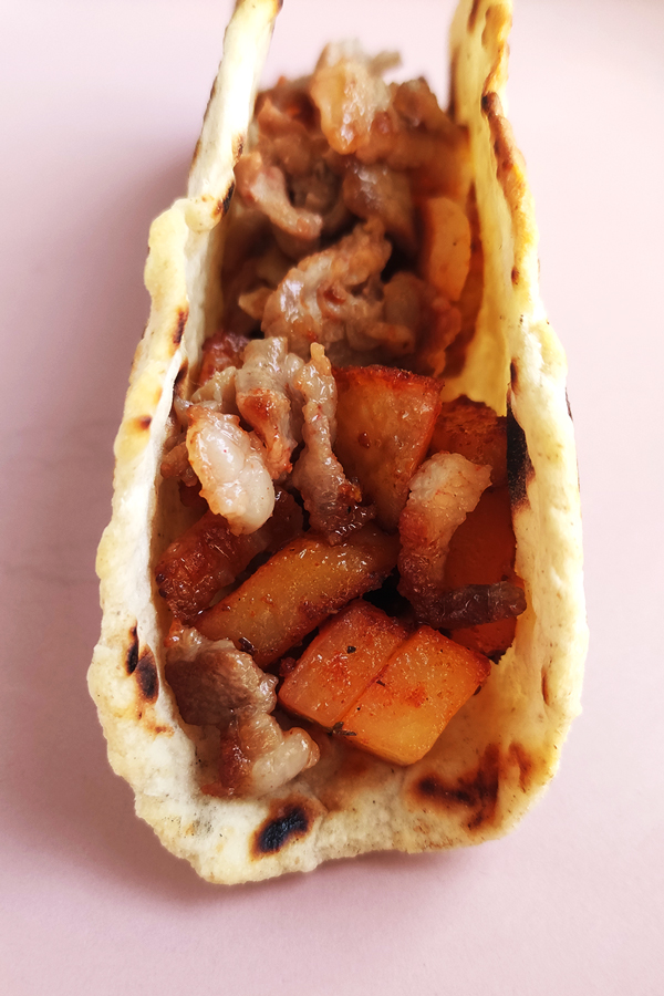 Filling tortillas with crispy potatoes and bacon