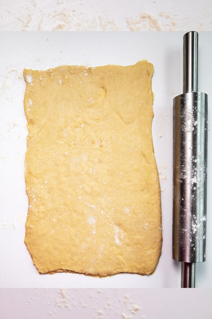 Rolling out the dough into a large rectangle 