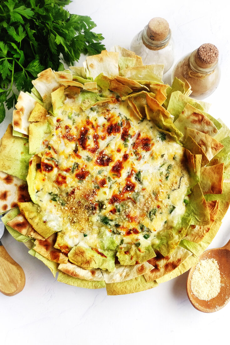 Serving queso dip with Parmesan cheese on top