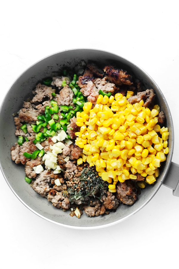 Cooking beef, onion,  corn, salt, pepper, taco seasoning, minced garlic, and half the chopped chili.