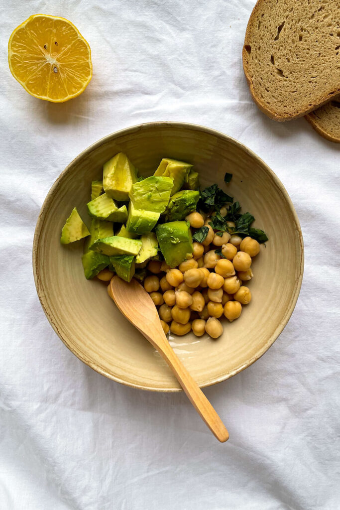 Mixing chickpeas and avocado