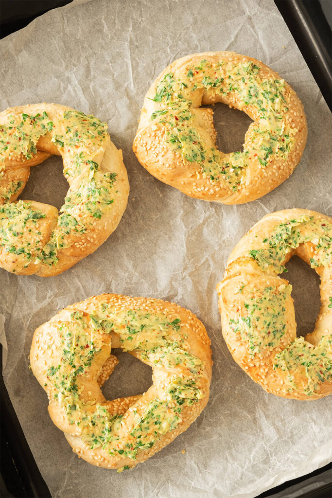 Spreading the garlic butter on the bagels