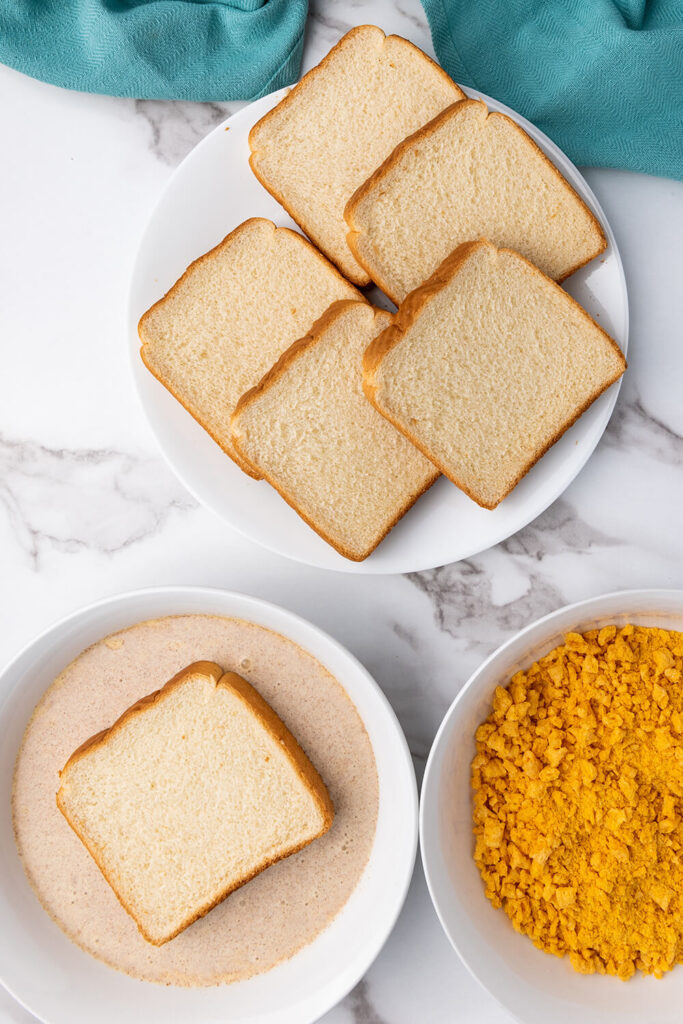 Dipping a slice of bread into the egg mixture