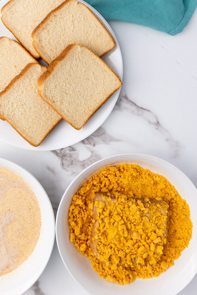 Dipping the bread into the crushed cereal