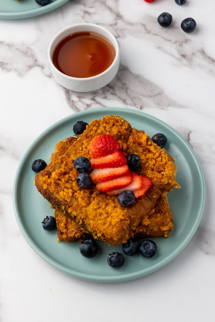 Serving the crunchy French toast with fresh berries and maple syrup