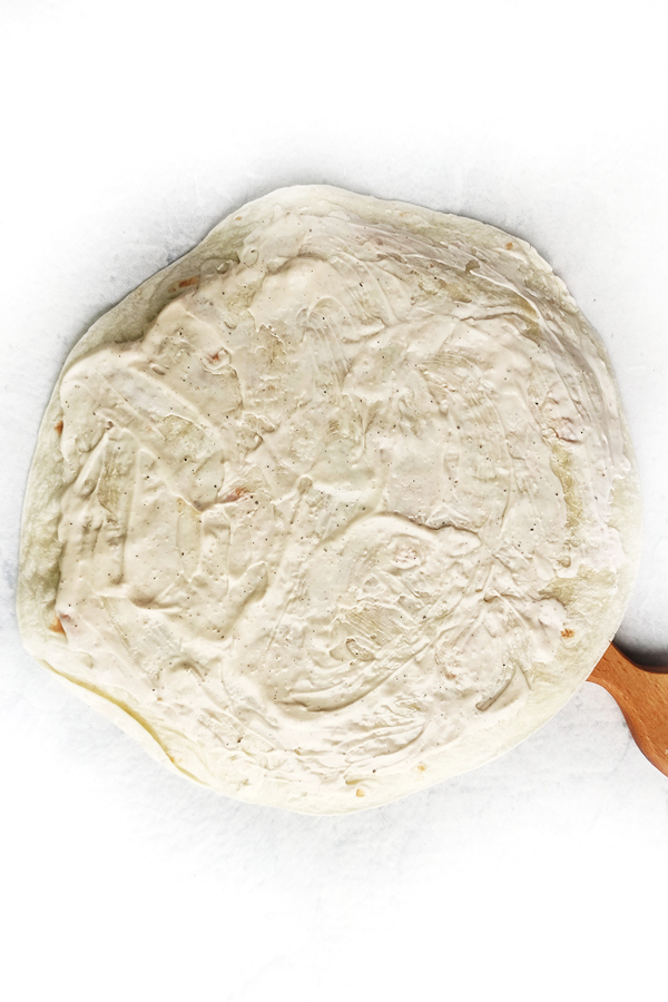 Covering tortilla with Caesar dressing