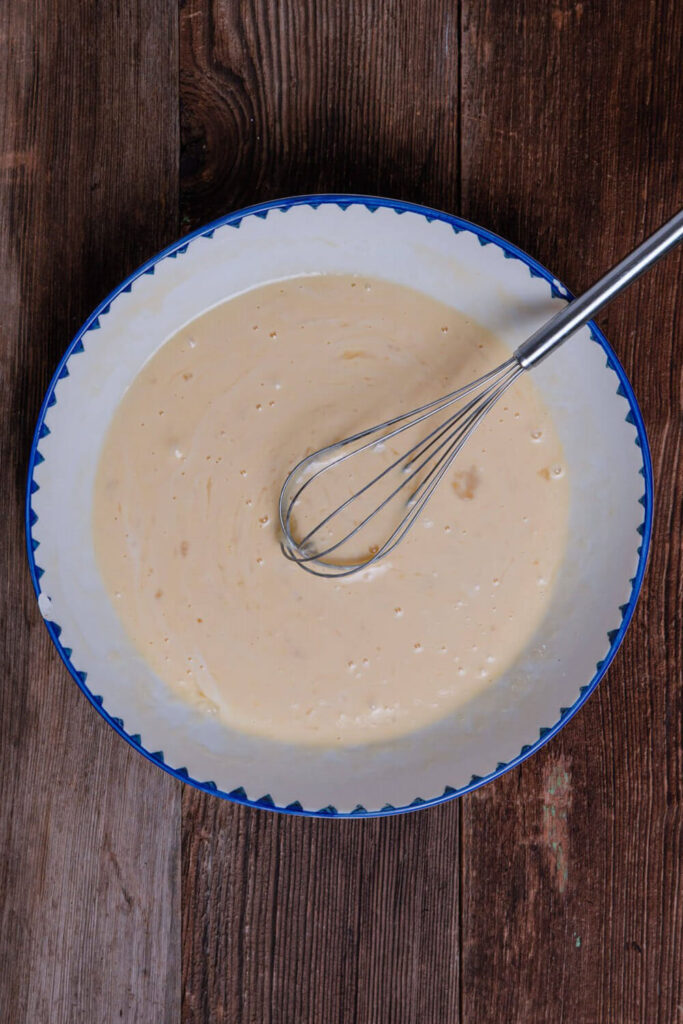 Mixing the eggs, coconut milk, vanilla, and salt