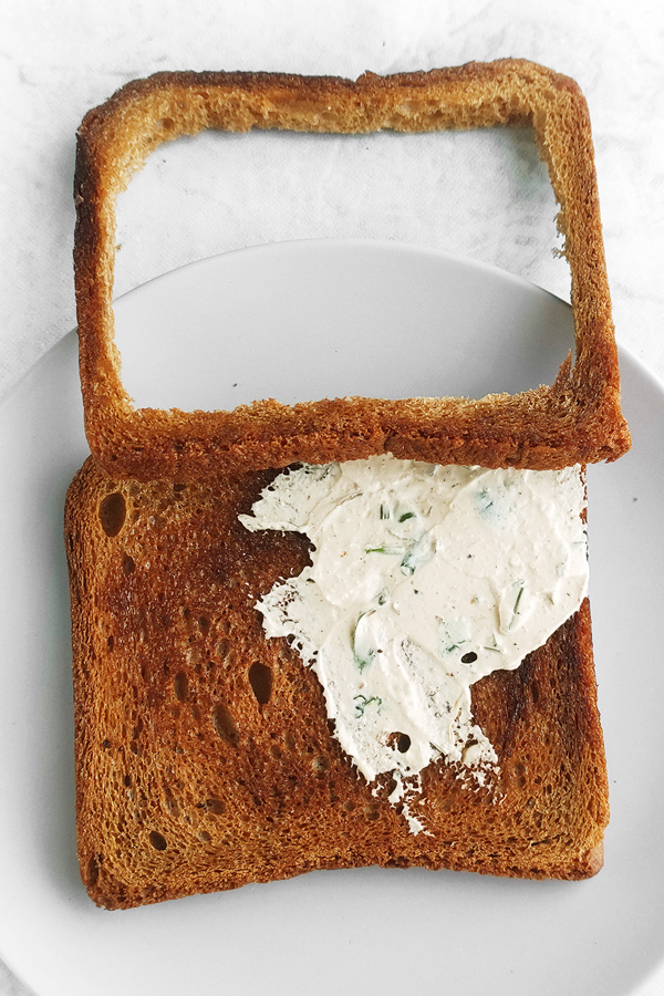 Spreading whipped feta in between breads