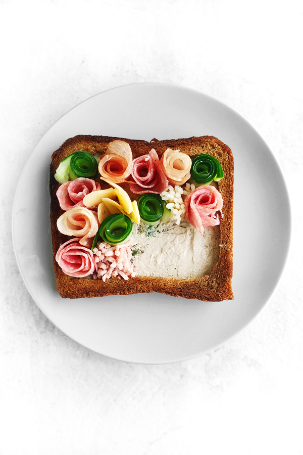 Adding all the Charcuterie into the sandwich