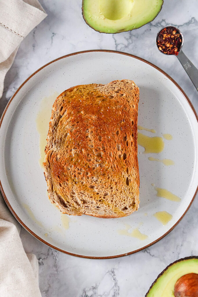 Drizzling olive oil on top of your toasted bread