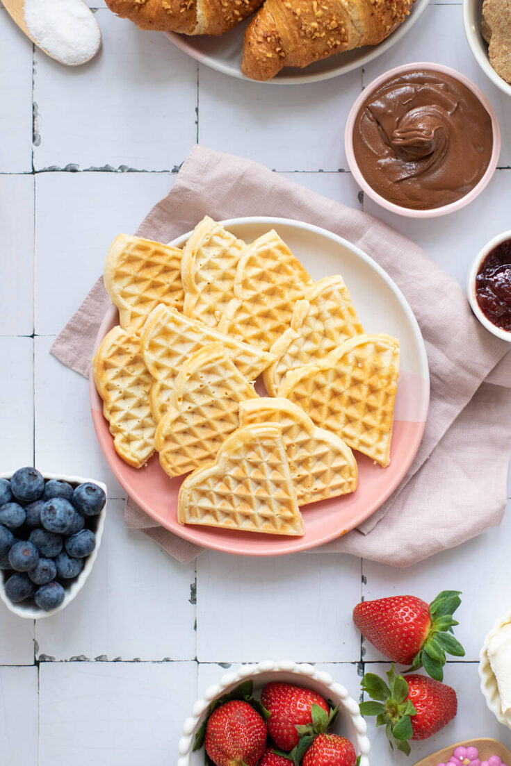 Serving the heart shaped waffles with different toppings