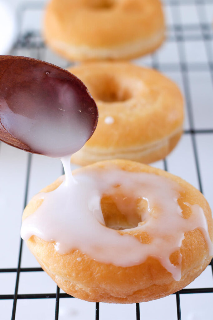 Drizzling donuts with icing