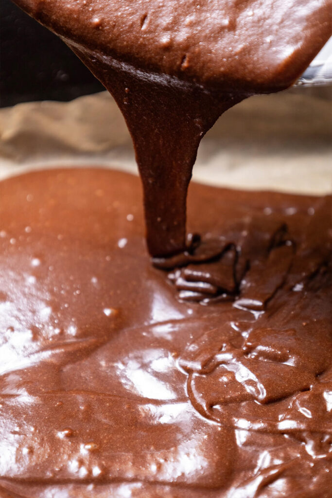 Pouring the brownie batter into the tin