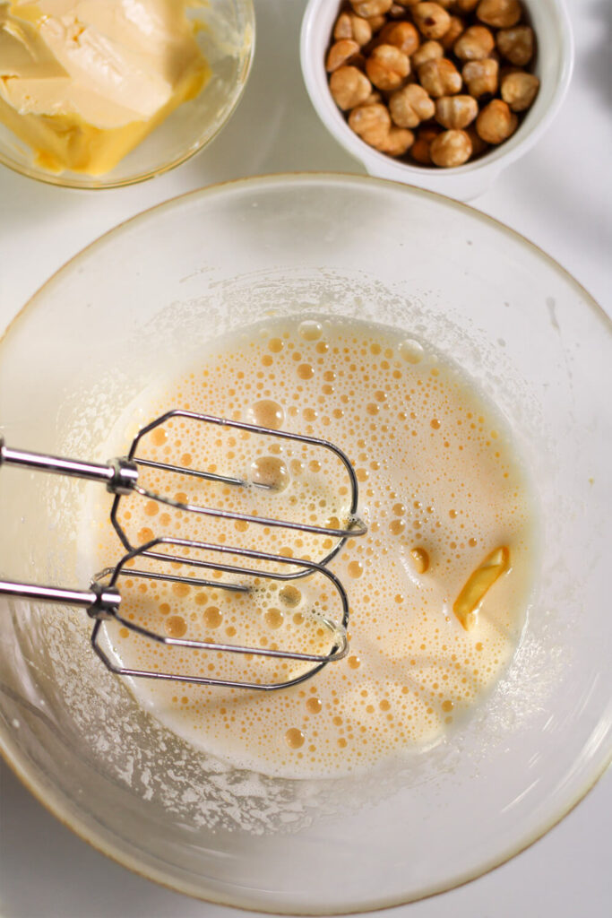 Mixing in the butter with an electric mixer