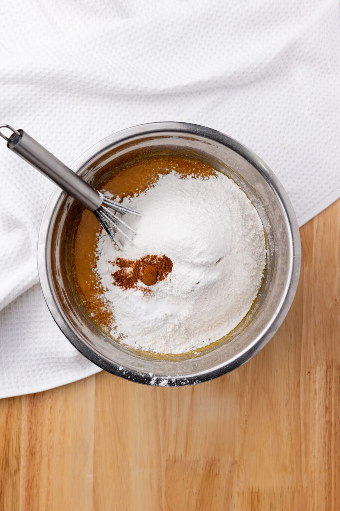 Adding flour, baking powder, baking soda, salt, and cinnamon 