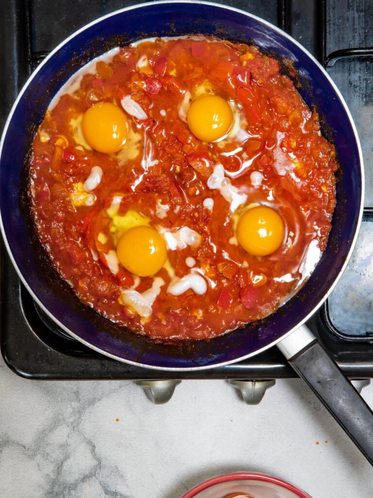 Cracking an egg into each well