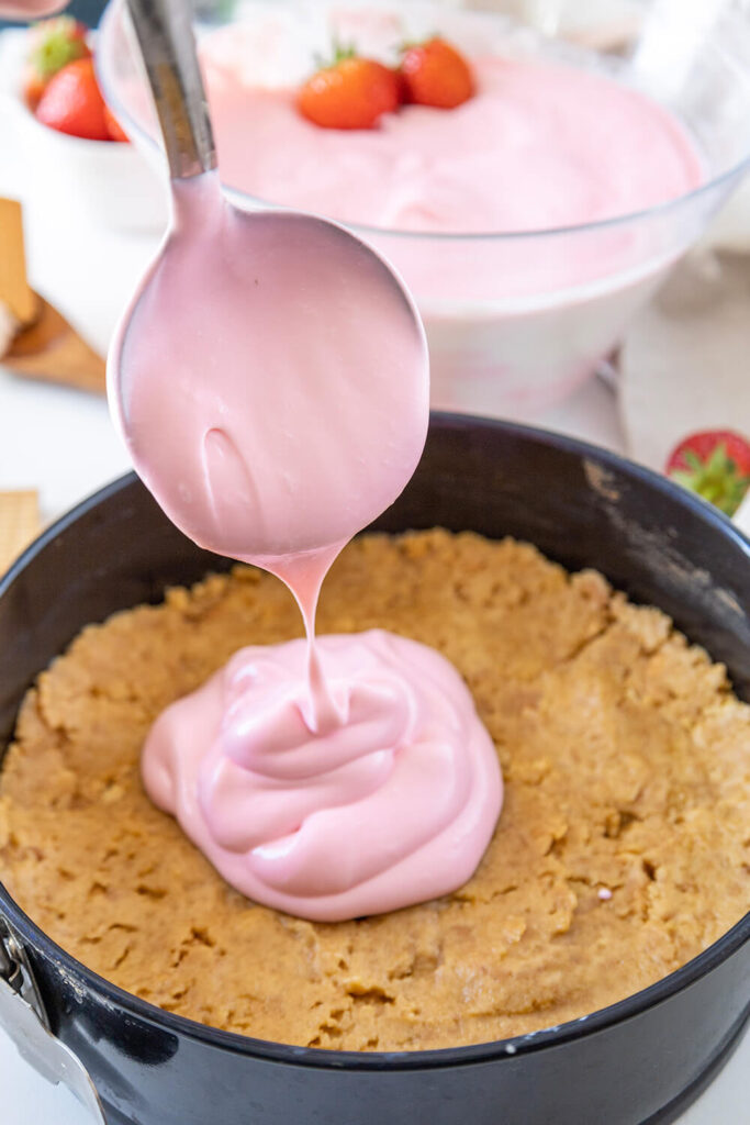 Pouting the cheesecake mixture on top of the crust