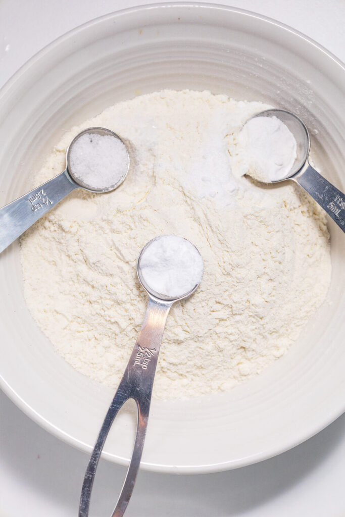Mixing flour, sugar, salt, baking soda, and baking powder
