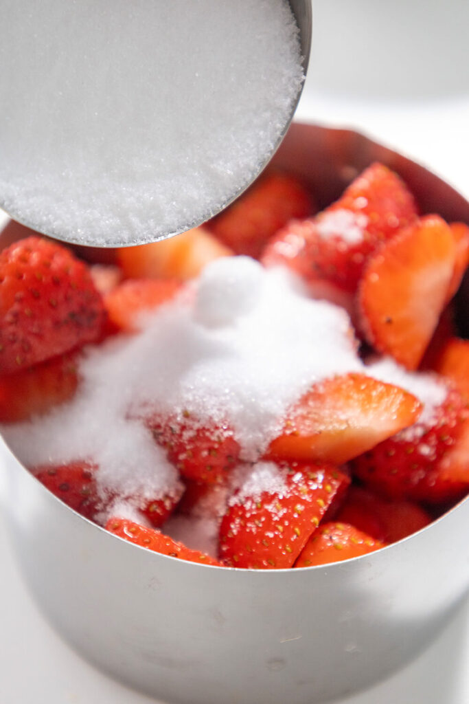 Mixing diced strawberries and sugar