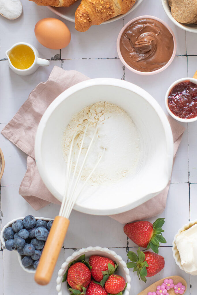Mixing flour, sugar, baking powder, and salt
