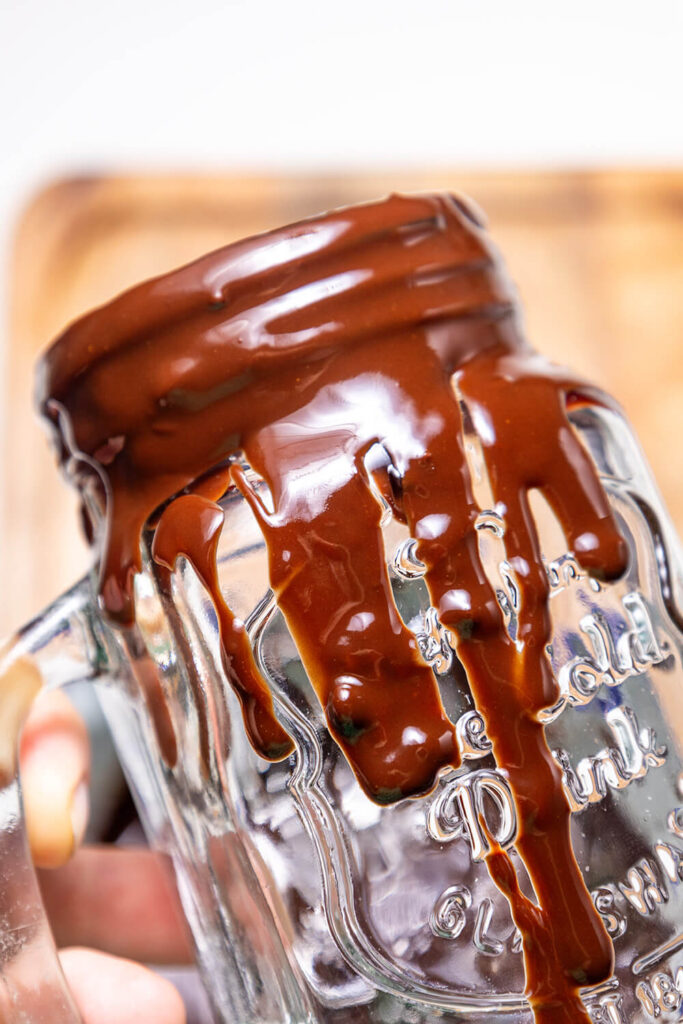 Spreading chocolate on the inside and outside of the glass