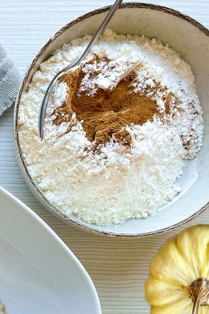 Mixing the flour, baking soda, baking powder, salt, pumpkin pie spice, and coffee granules
