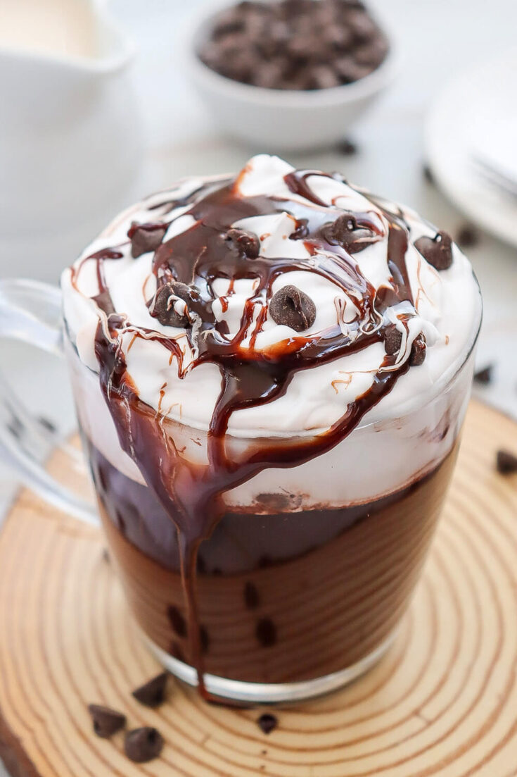 Serving the Hot Chocolate with whipped cream, chocolate chips, and a drizzle of chocolate