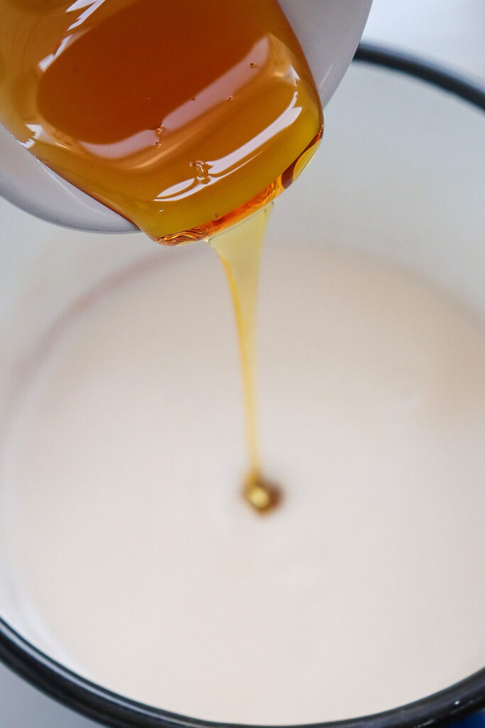 Poring almond milk and maple syrup on a sauce pan